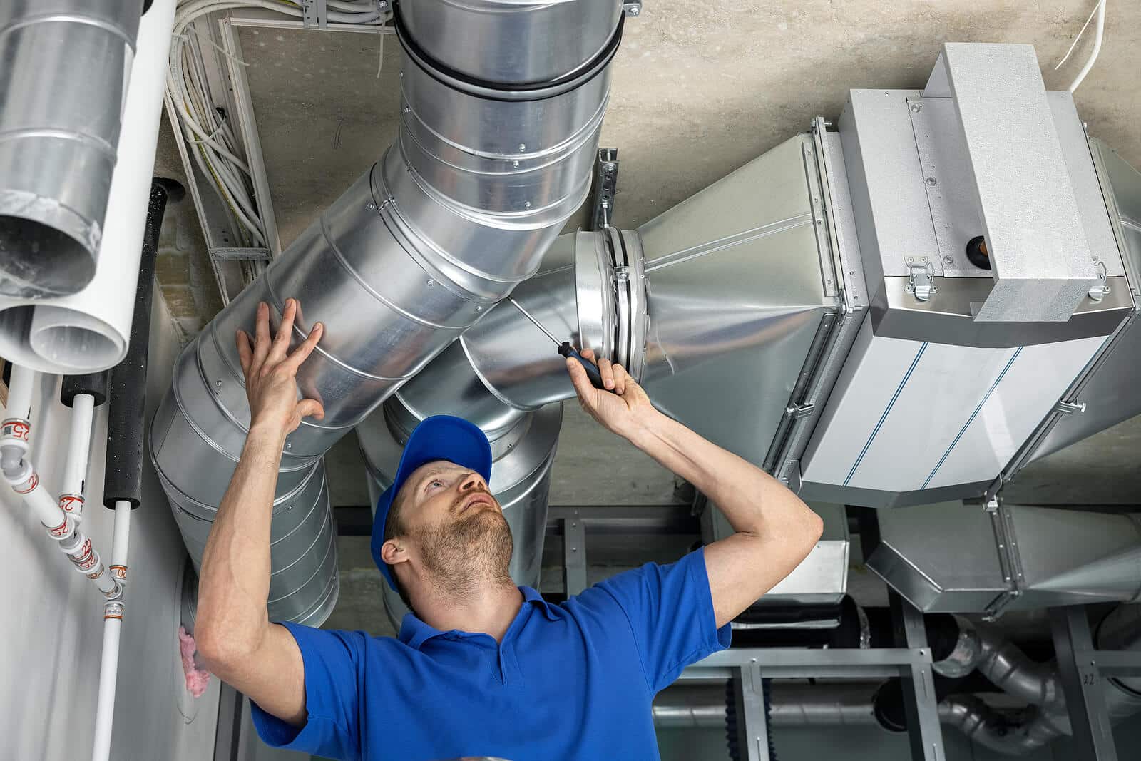 HVAC technician inspecting and repairing air ducts in Goleta