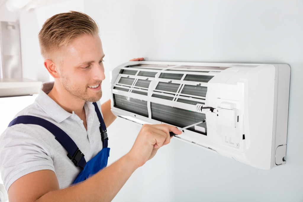 HVAC technician maintaining a ductless air conditioner in Goleta