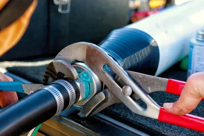 Technician repairing an industrial pipe connection in Goleta
