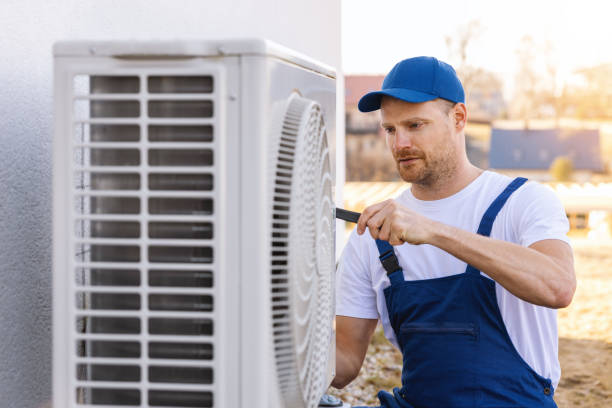 HVAC technician servicing an outdoor air conditioner in Goleta