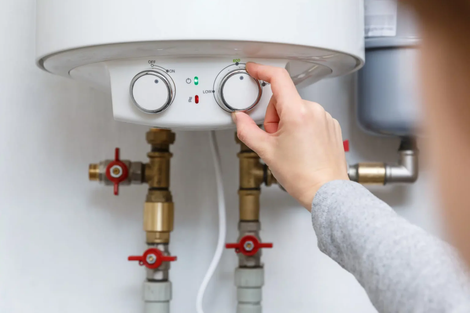 Technician adjusting a water heater in Goleta